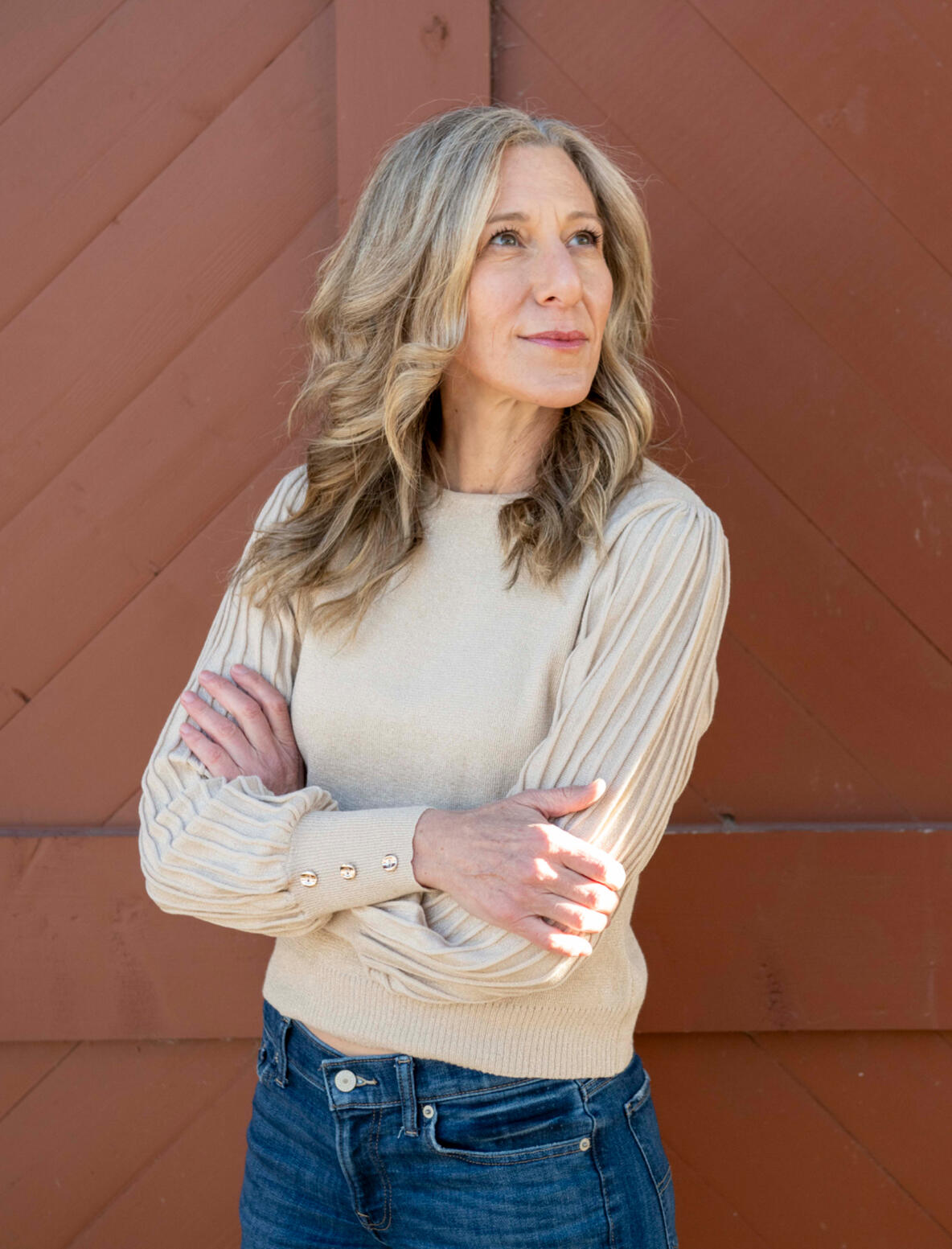 Global Love Writing Liz Brown Morgan Bio Picture Liz Brown Morgan, ghostwriter and founder of Global Love Writing, standing with arms crossed.